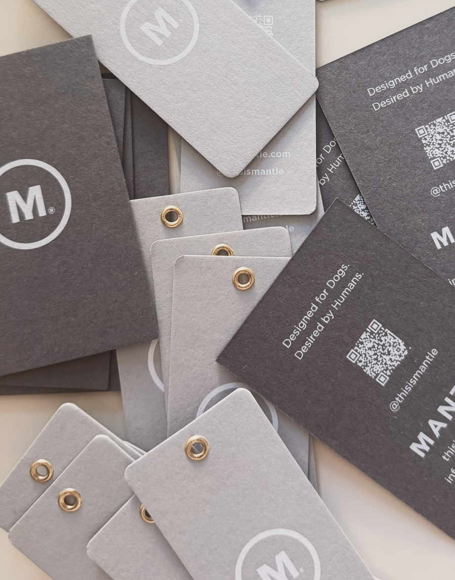 MANTLE branded print business cards and  hang tangs with brass grommet details with white ink on dark and light grey card stock