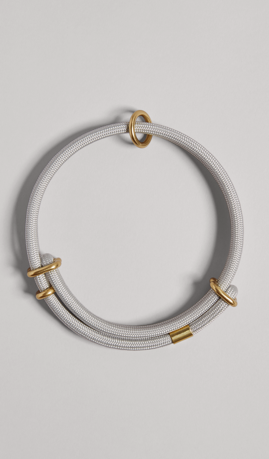 The MANTLE® dog collar in Haze with solid brass hardware, shown from an overhead view on a light gray background