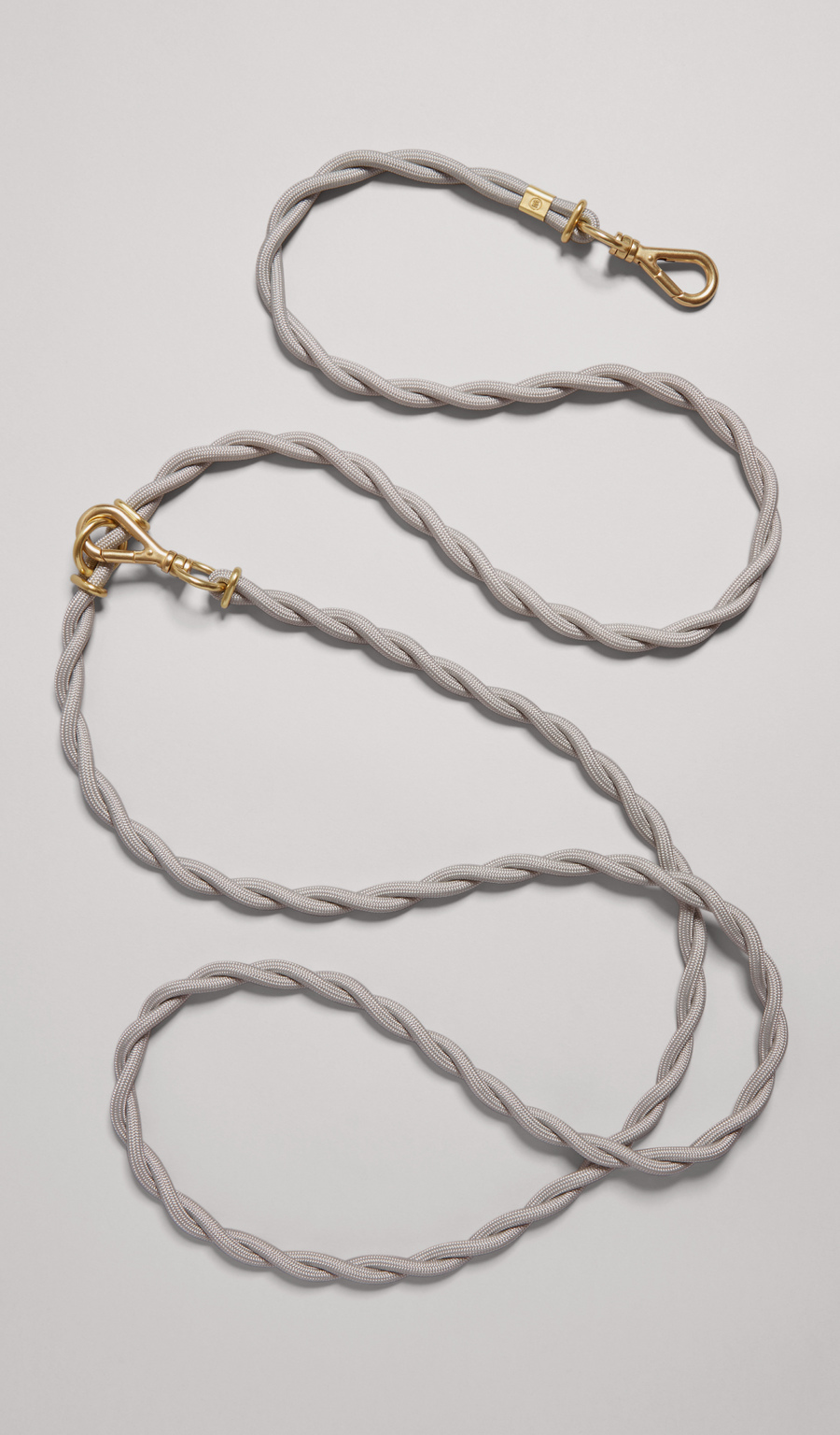 The MANTLE® dog crossbody leash in Haze with solid brass hardware, shown from an overhead view on a light gray background