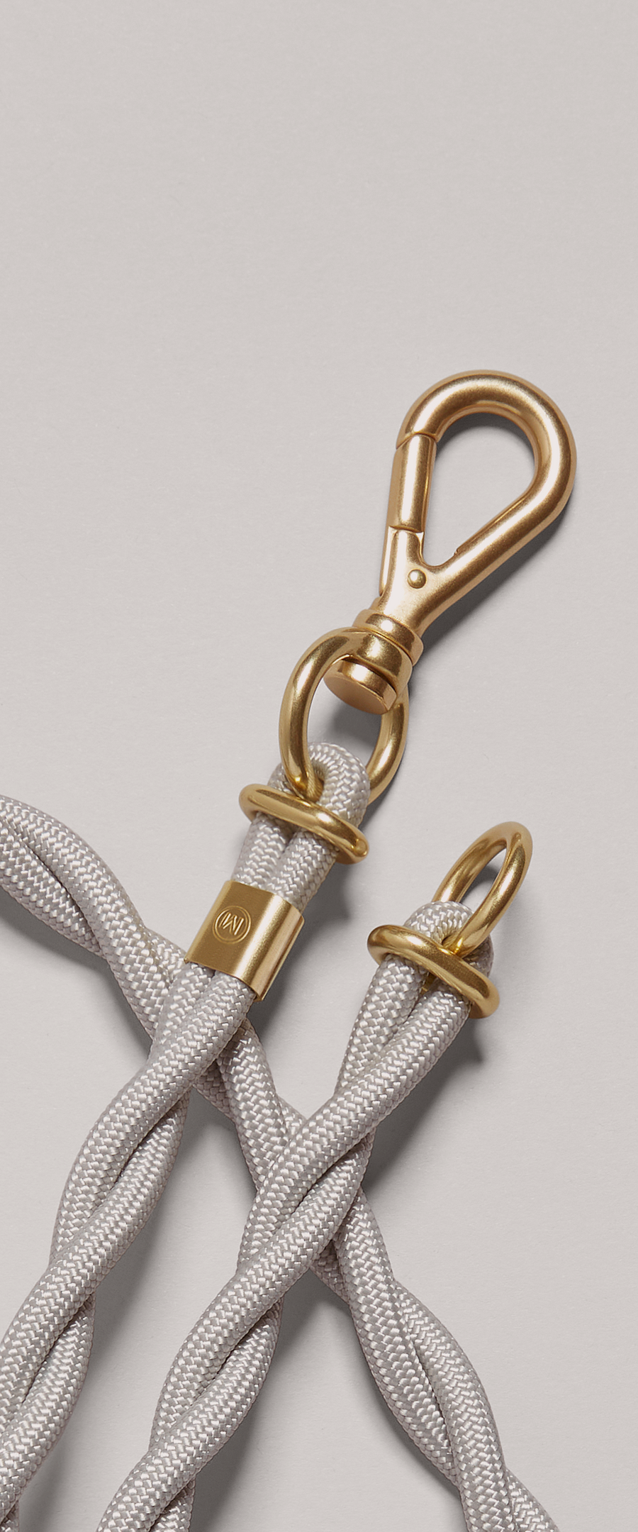 Detail of MANTLE® dog system lead in Haze with solid brass hardware, close up view of solid brass connection ring and clip attachment on a light gray background