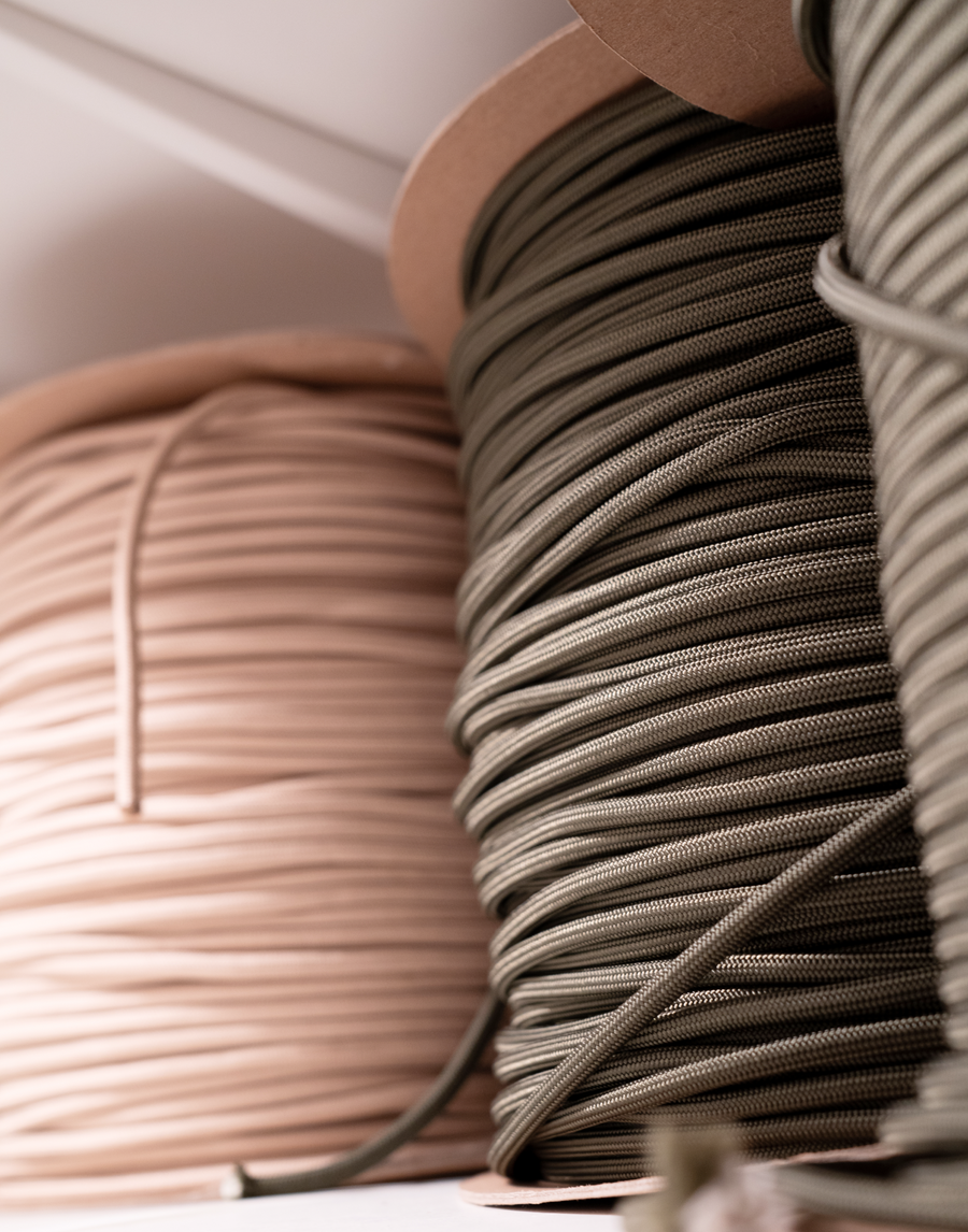 Close up of bulk cord spools in Sand and Moss used to produce MANTLE® dog walking accessories