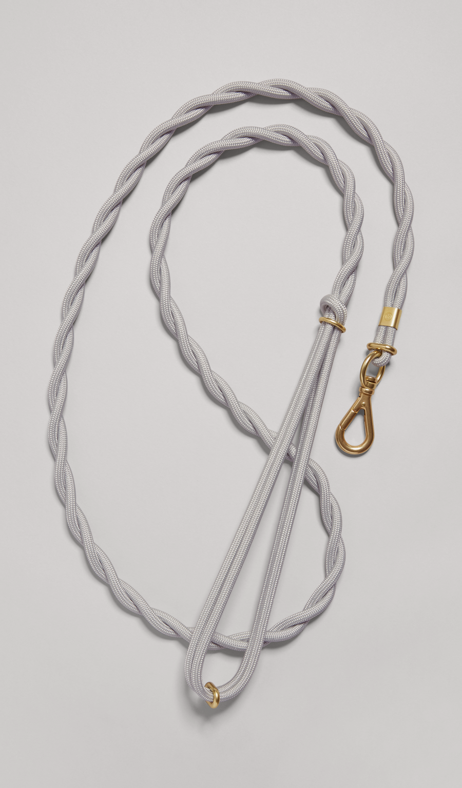 The MANTLE® dog leash in Haze with solid brass hardware, shown from an overhead view on a light gray background