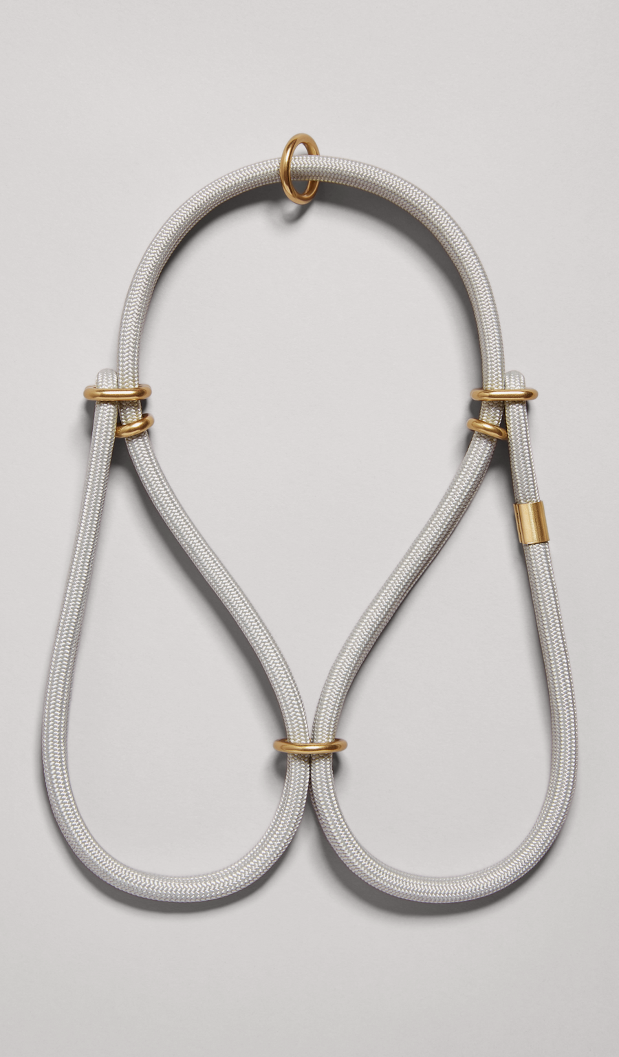 The MANTLE® dog step-in harness in Haze with solid brass hardware, shown from an overhead view on a light gray background