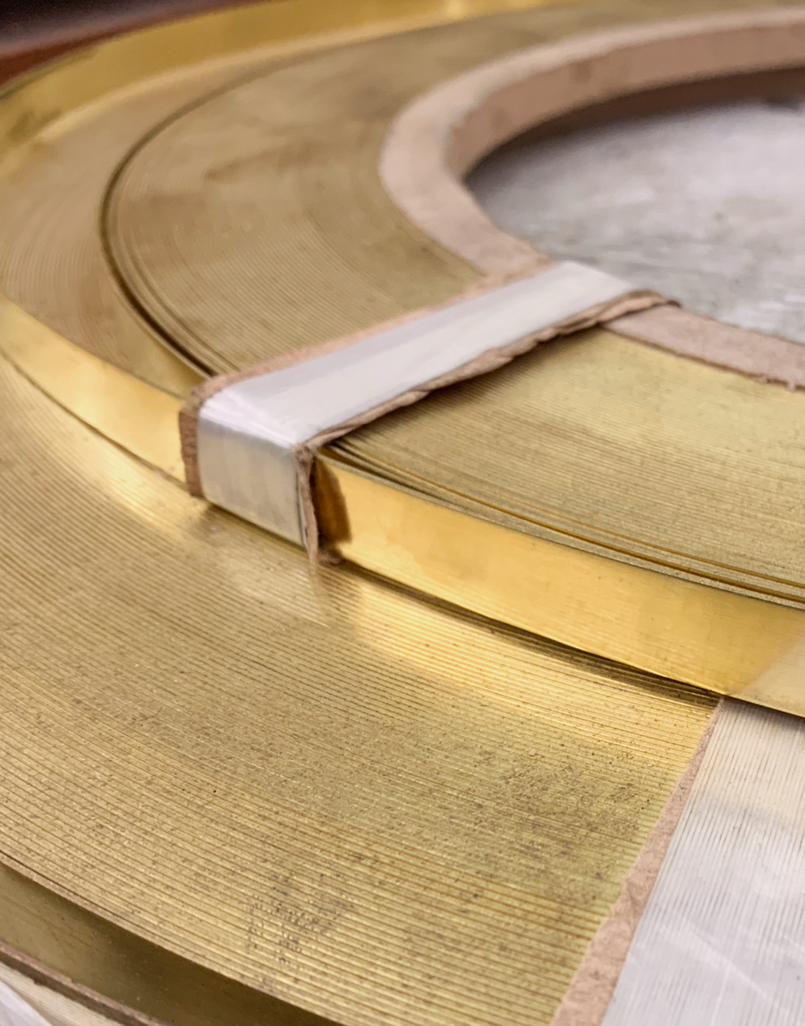 Detail of raw solid brass that is used to to stamp out and form the custom MANTLE branded connection clamp